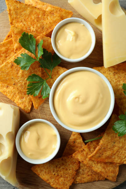 istock Concept of snack with chips and cheese sauce, top view 1482792134