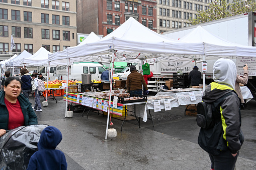 New York City, USA, April 5, 2023 - People walk and shop at the Union Square Greenmarket.