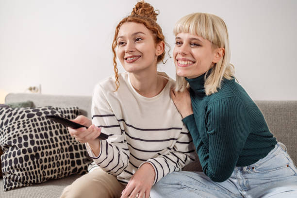 istock Friends watching TV show at home 1482792175
