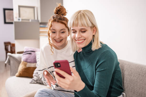 istock Two young woman looking at the phone 1482792230