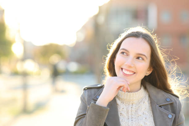 istock Happy woman is thinking looking at side 1482792514