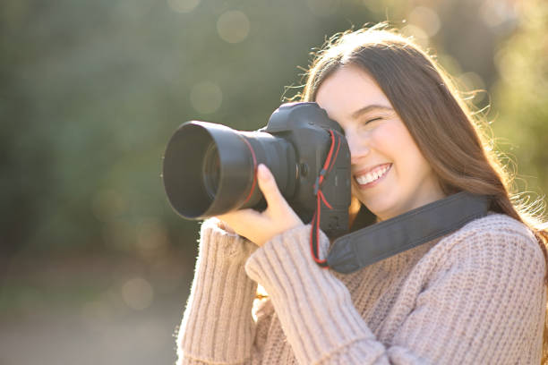 istock Woman taking photos in winter with pro camera 1482792529