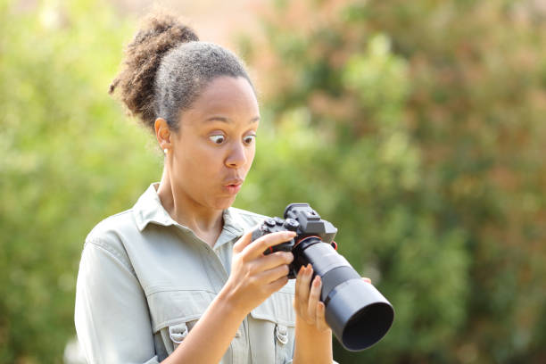 istock Surprised black photographer checking photos on camera 1482792551