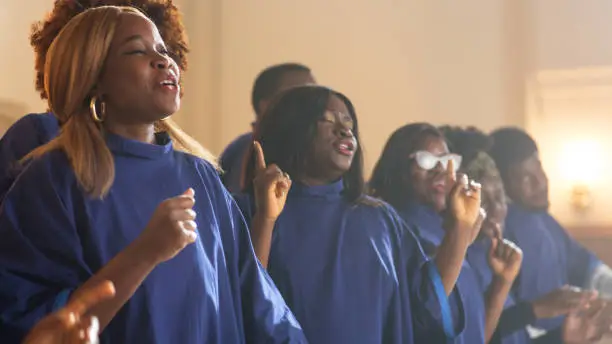 Photo of Group Of Christian Gospel Singers Praising Lord Jesus Christ. Song Spreads Blessing, Harmony in Joy and Faith. Church is Filled with Spiritual Message Uplifting Hearts. Music Brings Peace, Hope, Love