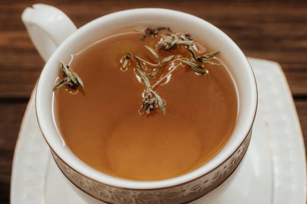 istock Herbal green tea in a white cup on the table 1482792625