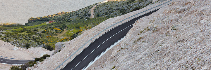 A new road on a mountain slope on the coast.