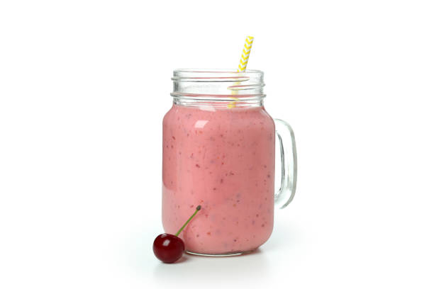 istock Glass jar of cherry smoothie isolated on white background 1482796992