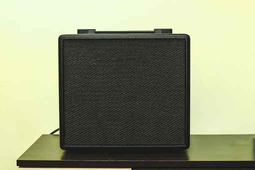 Black combo amp speaker for electric guitar.