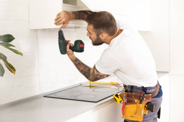 istock Male Worker Fixing Kitchen Hood With Screwdriver In Kitchen 1482799762