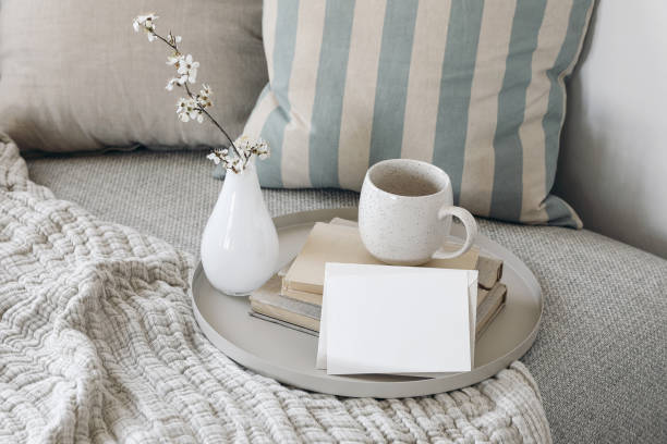 istock Spring birthday greeting card, wedding invitation. Easter breakfast still life. Blank greeting card mockup. Cup of coffee, tea on books. Blossoming cherry plum tree branches in little glass vase. 1482799773