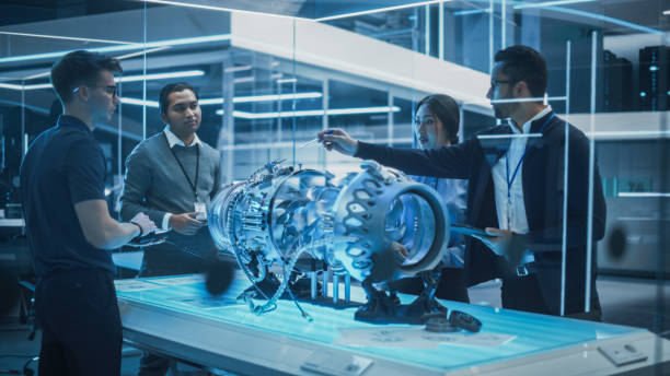 istock Diverse Multiethnic Team of Industrial Engineers Gathered Around a Table With a Prototype Turbine Engine. Scientists Use Tablet Computer to Research, Develop and Program the Futuristic Motor. 1482800025