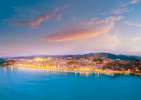 Lloret de Mar sunset beach village aerial skyline in Girona Catalonia on Mediterranean sea of Spain. Costa Brava Coast
