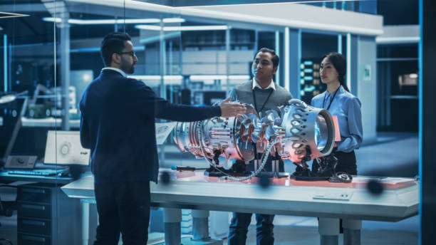istock Smart Team of Engineers, Project Manager and Machinery Operators Collaborate on a New Type of a Electric Turbine Engine, Standing with Tablet and Laptop Computers in Scientific Technology Lab. 1482801492