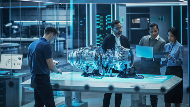 istock Smart Team of Engineers, Project Manager and Machinery Operators Collaborate on a New Type of a Electric Turbine Engine, Standing with Tablet and Laptop Computers in Scientific Technology Lab. 1482801501