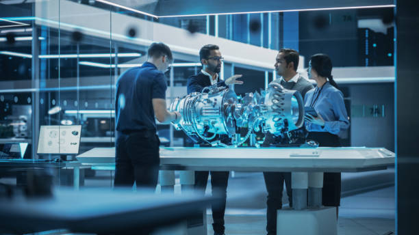 istock Smart Team of Engineers, Project Manager and Machinery Operators Collaborate on a New Type of a Electric Turbine Engine, Standing with Tablet and Laptop Computers in Scientific Technology Lab. 1482801514