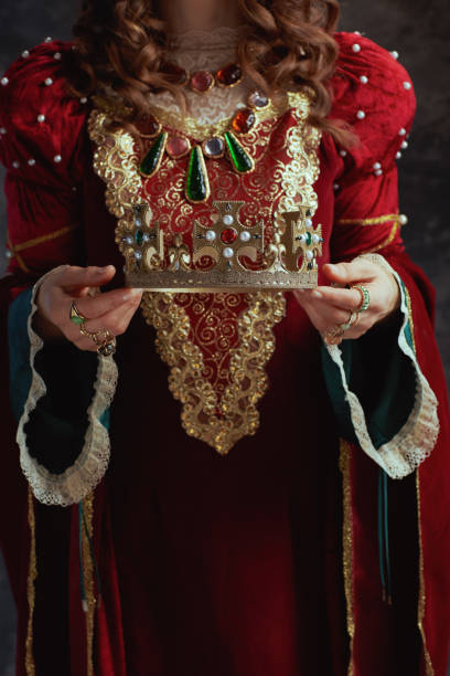 istock Closeup on medieval queen in red dress with crown 1482801534