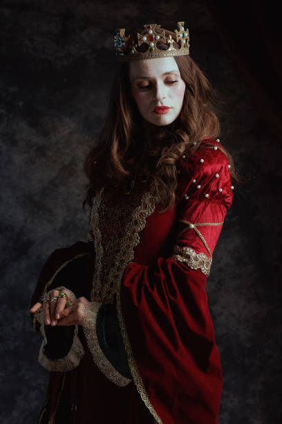 istock medieval queen in red dress with white makeup and crown 1482801543