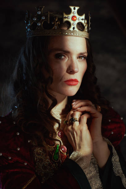 istock medieval queen in red dress with crown 1482801546