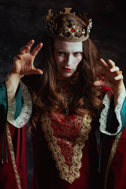 istock scary medieval queen in red dress with white makeup and crown 1482801549