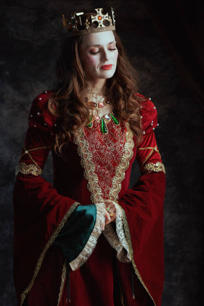 istock medieval queen in red dress with white makeup and crown 1482801551