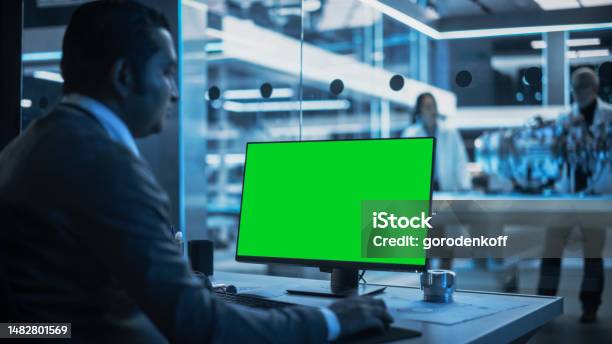 Software Developer Working On Computer With Green Screen Mock Up ...