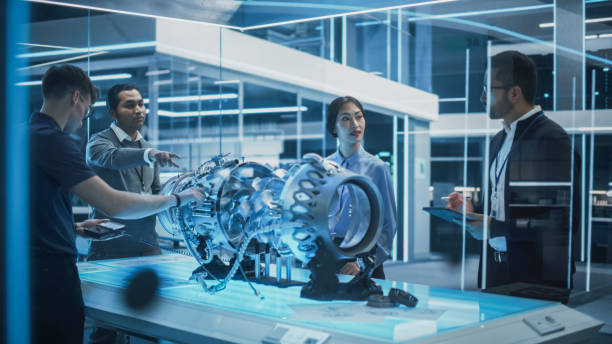 istock Young Team of Multicultural Engineers Use Blueprints, Tablet and Laptop Computers, Analyze and Discuss How a Modern Electric Turbine Motor Works. High Tech Research Laboratory with Modern Equipment. 1482802787