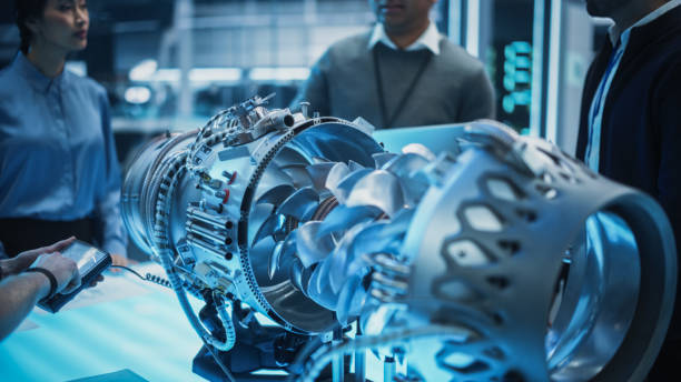 istock Young Team of Multicultural Engineers Use Blueprints, Tablet and Laptop Computers, Analyze and Discuss How a Modern Electric Turbine Motor Works. High Tech Research Laboratory with Modern Equipment. 1482802805