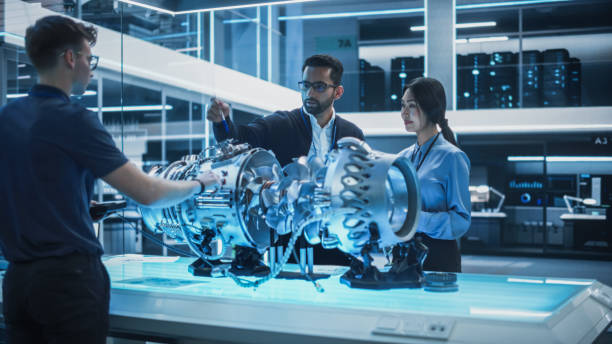 istock Young Team of Multicultural Engineers Use Blueprints, Tablet and Laptop Computers, Analyze and Discuss How a Modern Electric Turbine Motor Works. High Tech Research Laboratory with Modern Equipment. 1482802829