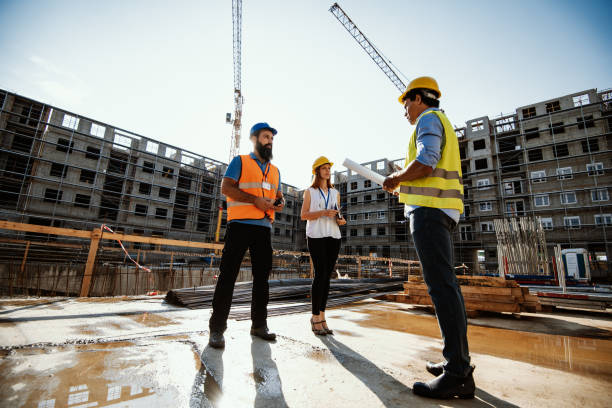 istock Wide angle shot of three engineers under the construction cranes 1482803069