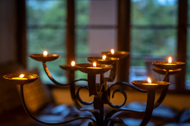 The flaming candles on a candlestick in evening. Close up