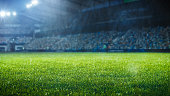 Establishing Shot of Empty Football Socer Stadium. International Tournament Concept. A crowd of Fans Cheer on the Tribune. Beginning of Sports Final Game. Cinematic Shot of Crowded Arena.