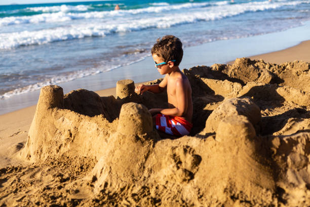 istock Boy building a sand castle on the beach 1482806835