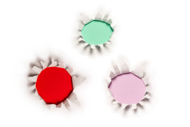istock A hole in a white paper on a red background. 1482810531