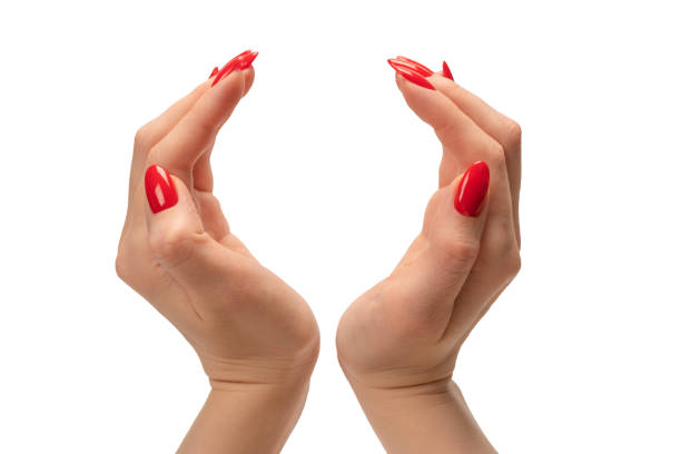 istock Woman hand with red nails holding something. 1482810582
