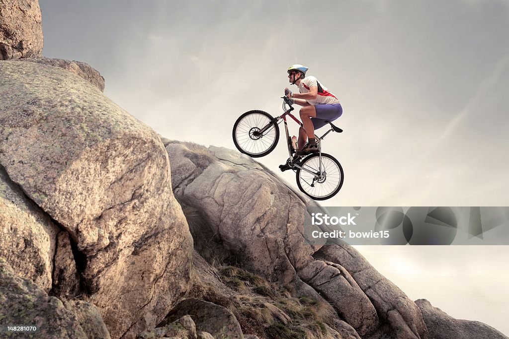 Hard track Cyclist climbing uphill on some rocks Cycling Stock Photo