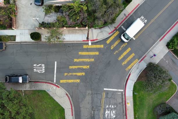istock Aerial view of an intersection surrounded by greenery in the daylight 1482810825