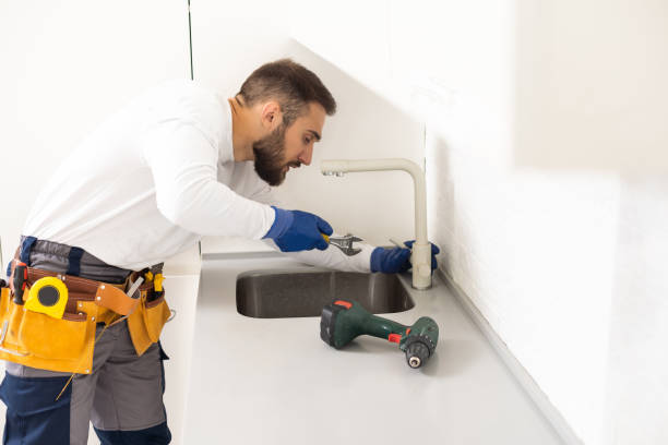 istock Side View Of A Plumber Fixing Water Tap In Kitchen 1482812336