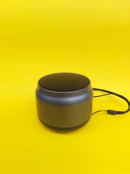 istock Black wireless portable bluetooth speaker, isolated on yellow background. 1482812661