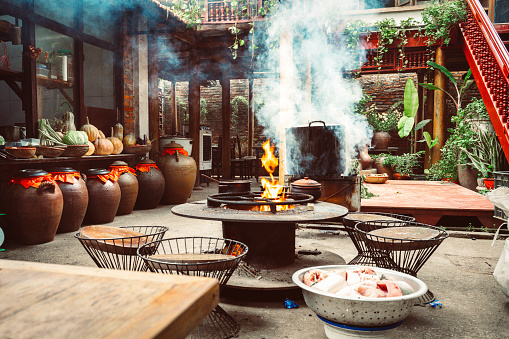huge steaming cooking pan on cooking on open fire in outdoor kitchen in restaurant in north vietnam