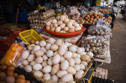 stacked boxes with fresh eggs at farmers market in vietnam