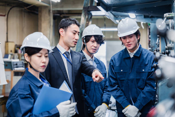 istock Management directing factory workers to be more efficient 1482814318