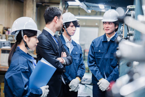 istock Management directing factory workers to be more efficient 1482814320