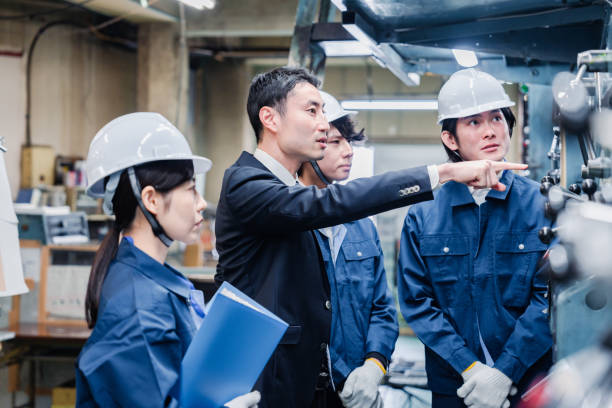 istock Management directing factory workers to be more efficient 1482814334