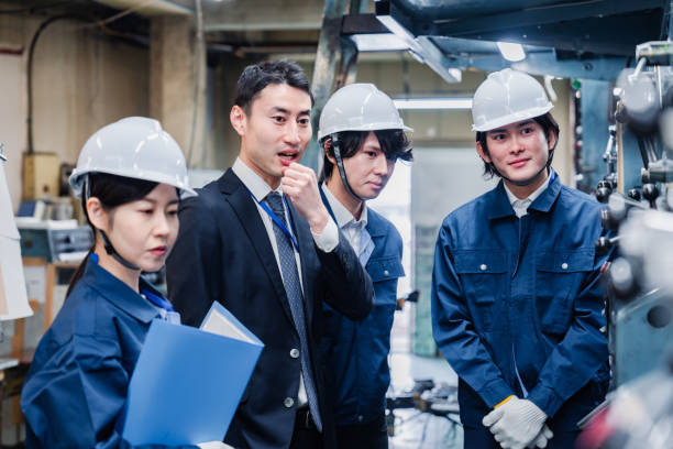 istock Management directing factory workers to be more efficient 1482814335