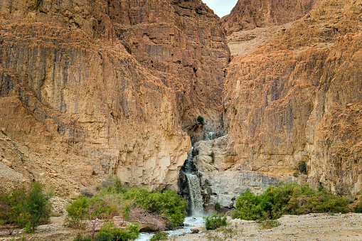 Unexpected powerful waterfall in the Judean Desert around the Dead Sea after heavy winter rains. This is one of the most famous deserts in the world.