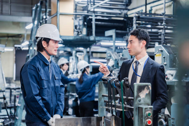 istock Management giving a warning to factory workers 1482816224