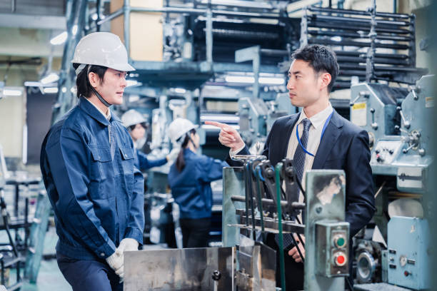 istock Management giving a warning to factory workers 1482816228