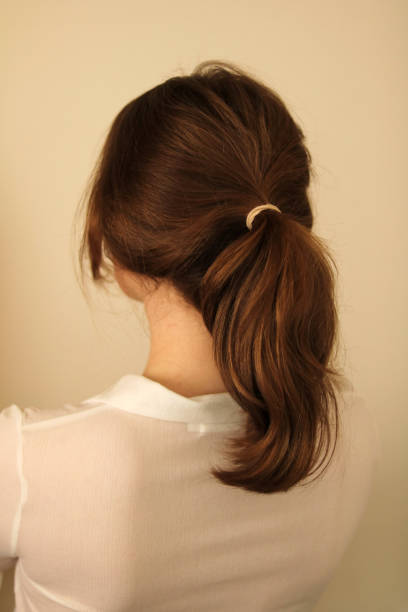istock Back view of woman with hair pulled back in a ponytail 1482816316