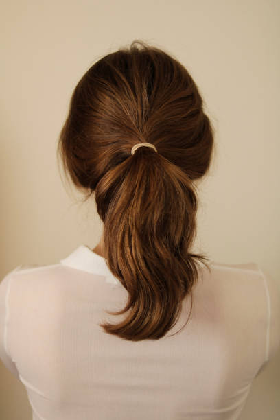 istock Back view of woman with hair pulled back in a ponytail 1482816343