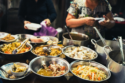 various bowls at food stall at street market in Hue, Vietnam